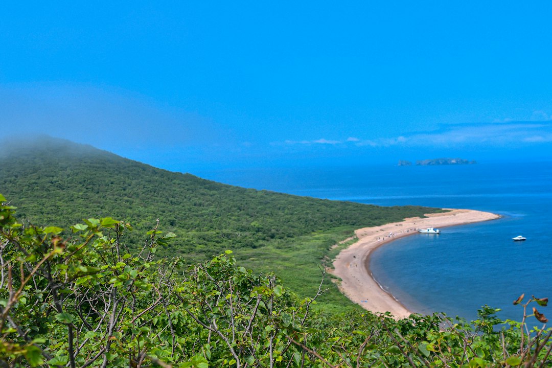 Remote coastal waters and boat illustrating the maritime geography of the Kuril Islands